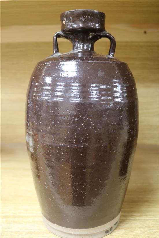 A Chinese late Ming brown glazed spouted jar